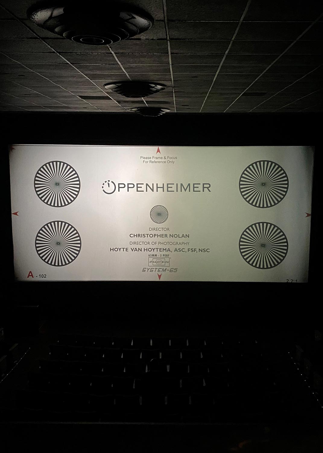 Movie screen displaying Oppenheimer frame and focus reference in a dark theater