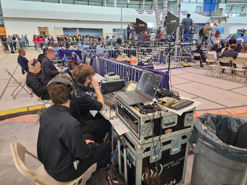 Production crew managing live broadcast at a public speaking event