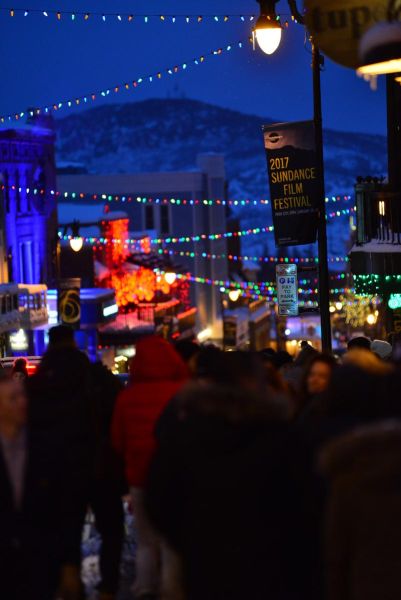 Colorful crowd-filled street with 2017 Sundance Film Festival banner