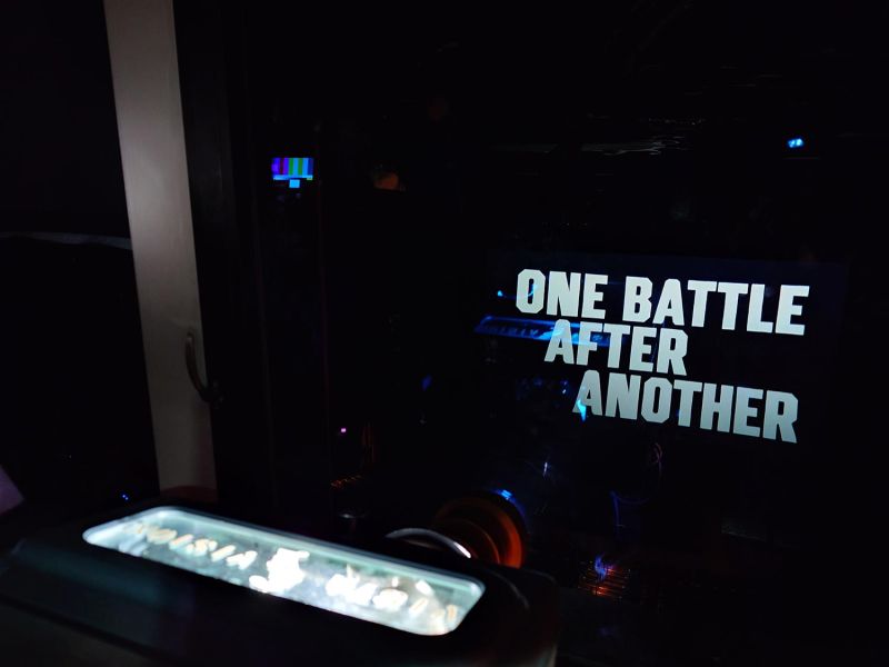 Movie title text projected onto a screen seen from inside a dark booth