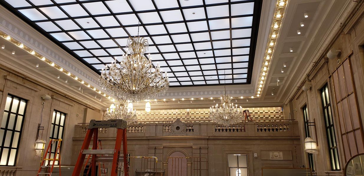 Elegant hotel ballroom with chandeliers and ceiling grid lighting