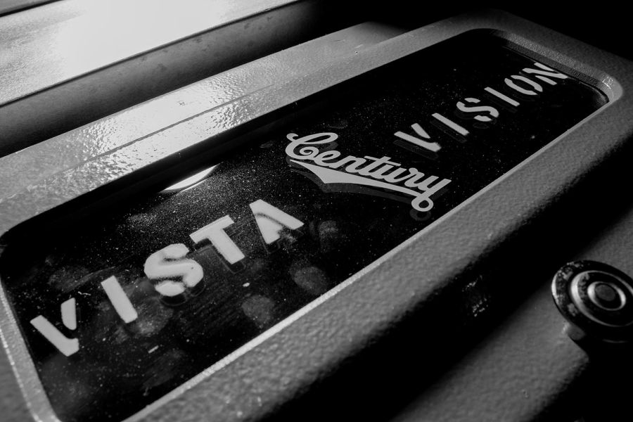 Black and white close-up of text engraved on vintage projection equipment
