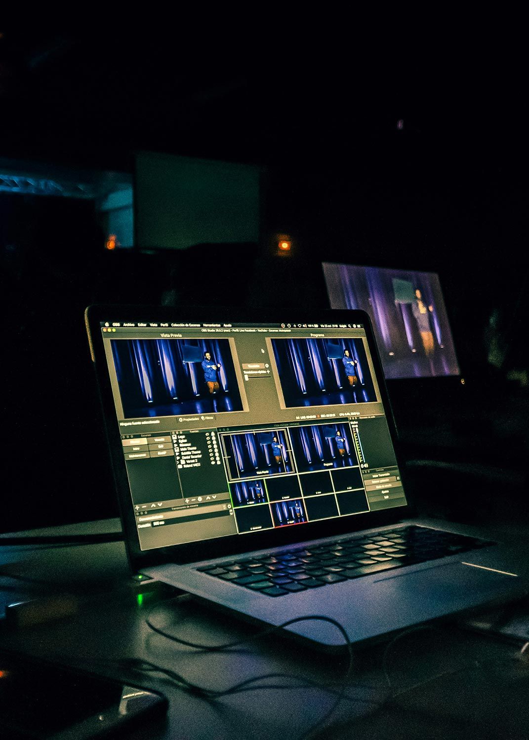 A laptop screen displaying a live streaming software interface with a stage performance in progress.